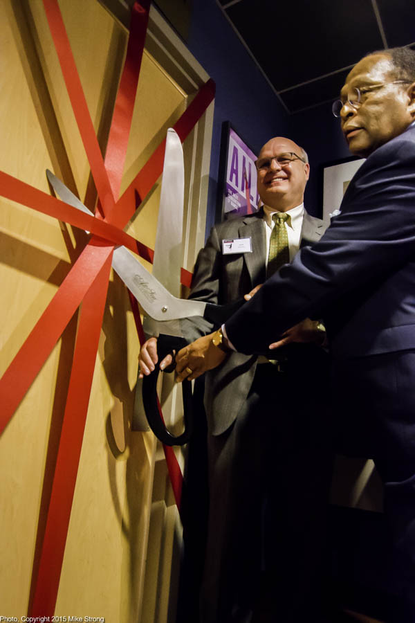 Scott Berghaus (left, Bank of America) and Roger C. Williams Jr Ed. D. (right, Board President) cut the ribbons to the studio door after a brief ceremony marking a donation from BOA to KCFAA renaming the studio to the David T. Beals III Studio at 18th and Vine.