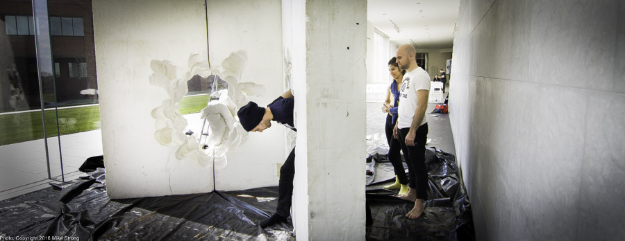 Checking out the Replica prop after construction (plaster of paris) - Jonah Bokaer goes through the wall and Laura Gutierrez and Szabi Pataki watch.