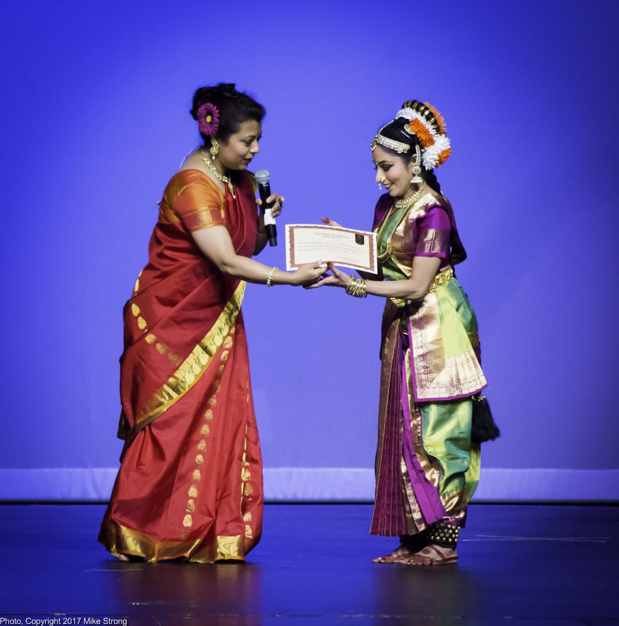 Teacher Samarpita Bajpai, Gurukul Academy, presents her certificate of graduation to Hema