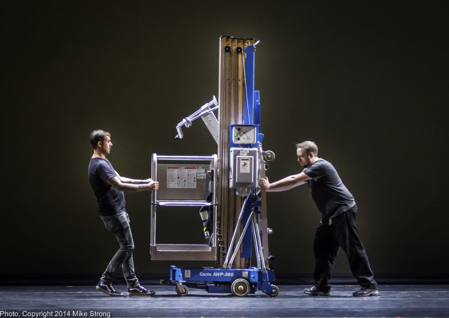 Stage crew moves a Genie lift