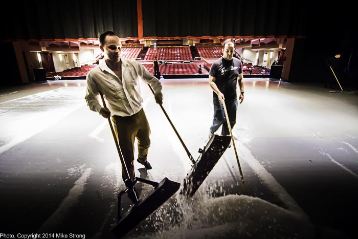 Dancer Dave Cross (left), playing one of the house guest parents and playing the Mouse King, pitches in to sweep snow to re-use it