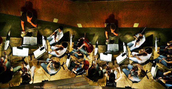 The orchestra pit for Dark Elegies, music by Gustav Mahler and ballet by Antony Tudor. This is a set of overlapped images with Robert C. Olson conducting (imaged twice in this picture). 